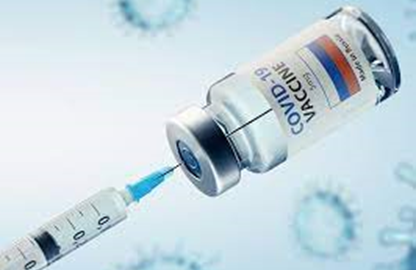 a photo of a vaccination needle and vial with the word COVID on label